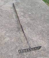 Full view of antique rake showing entire length