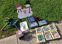 Overall lot showing tree stand, snowman decoration, ornaments boxes and other items