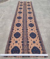 Full length view of rolled-out fabric showing entire pattern repeat and size