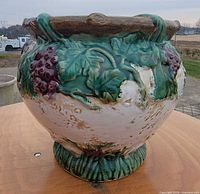 Side view of ceramic planter with grapevine relief