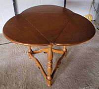 Tabletop with both leaves raised showing oval shape