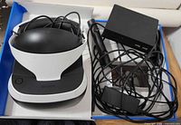 VR headset, processor unit, camera and cables inside box