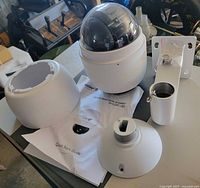Camera assembly with dome cover, wall mount bracket, base and manual