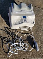 Front and top view of swing machine showing cradle and cord