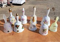 All nine bells grouped on tabletop outdoors