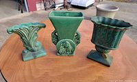 Three green glaze vases side by side