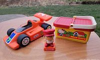 Overall lot showing Little Tikes car, Hello Kitty basket and Berries figure
