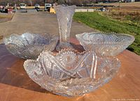 four pressed crystal pieces on table