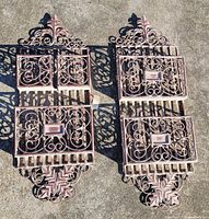 Two matching wrought iron letter holders on ground showing overall design