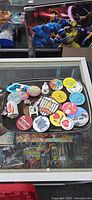Tray showing pins, patches and novelty pieces