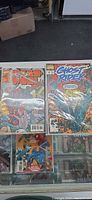 Glass counter view with Deadpool issue and Ghost Rider No.28, both bagged and boarded