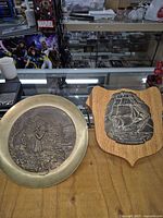 Overview showing both wall decor items side by side on table