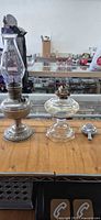 Group shot of metal oil lamp, glass oil lamp, stainless burner