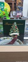 Jeweled Christmas Tree trinket box in front of branded box
