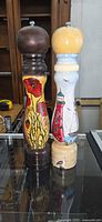 Front view of both pepper mills showing painted designs
