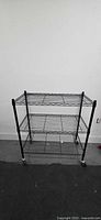 Front view showing three wire shelves and locking casters