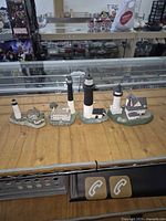 All four lighthouse replicas lined on counter