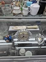 Four items grouped: lead crystal clock, leaf dish, blue perfume bottle, ice cream slicer
