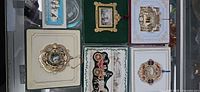 Overview showing five boxed ornaments and extra box