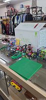 Overall lot showing assembled LEGO builds, baseplate in foreground