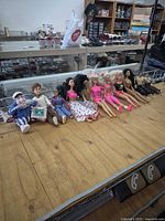 Full lot laid in a row on table showing dolls and action figure