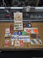 Full layout of all pins, patches, stickers, perfume, tape measure, paperclip and matchbook