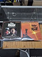 Stack of laserdiscs topped with The Boat and Fiddler on the Roof jackets