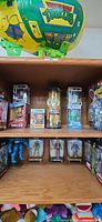 Overall shelf with TMNT Turtle Blimp, boxed figures on two levels