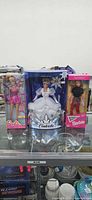 Group shot of three sealed Barbie dolls in boxes