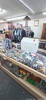 View of countertop with numerous zip bags filled with Lego pieces and white box