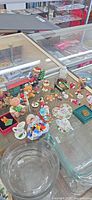 Group of miniature ornaments displayed in glass case
