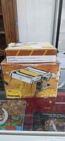 Outer box of Atlas 150 pasta maker and smaller box on top