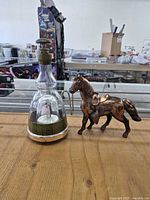 Decanter and horse figurine side by side