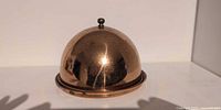front view of copper-plated dome on base