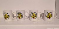 All four mugs front view showing Giant Tiger logo