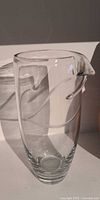 Clear glass pitcher-style vase showing full form and spout