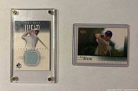 Both cards side by side; rookie card in top loader, swatch card in acrylic case