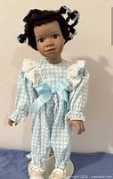 Front view of doll in outfit on stand