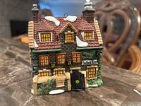 Front view of Dedlock Arms ornament showing facade, windows, snow detail and hanging loop