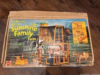 Top of original Sunshine Family Farm cardboard box showing artwork and Mattel branding