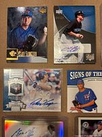 Four of the autographed cards including Mike Sirotka, Curtis Thigpen, David Cooper, Jason Arnold