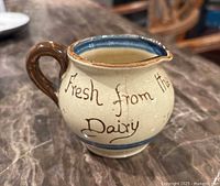 Side view showing script "Fresh from the Dairy" and overall glaze finish