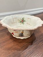 Top angle of ceramic bowl showing scalloped rim, holly motif and "Merry Christmas" script
