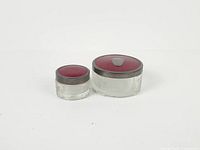 Large and small vanity jars with lids on