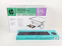 Sealed boxes of HP DeskJet 2855e printer and Logitech MK270 keyboard/mouse set