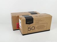 Two sealed Amazon Basics 50-count pet training pad boxes side by side