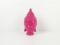 Front view of pink ceramic Buddha head figurine