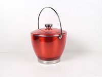 Front view of red acrylic ice bucket with lid, handle up