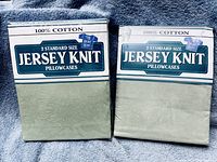 Front view of two sealed packages labeled 100% Cotton Jersey Knit Pillowcases
