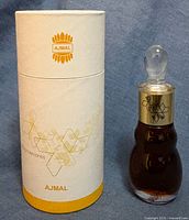 Ajmal attar bottle beside original tube